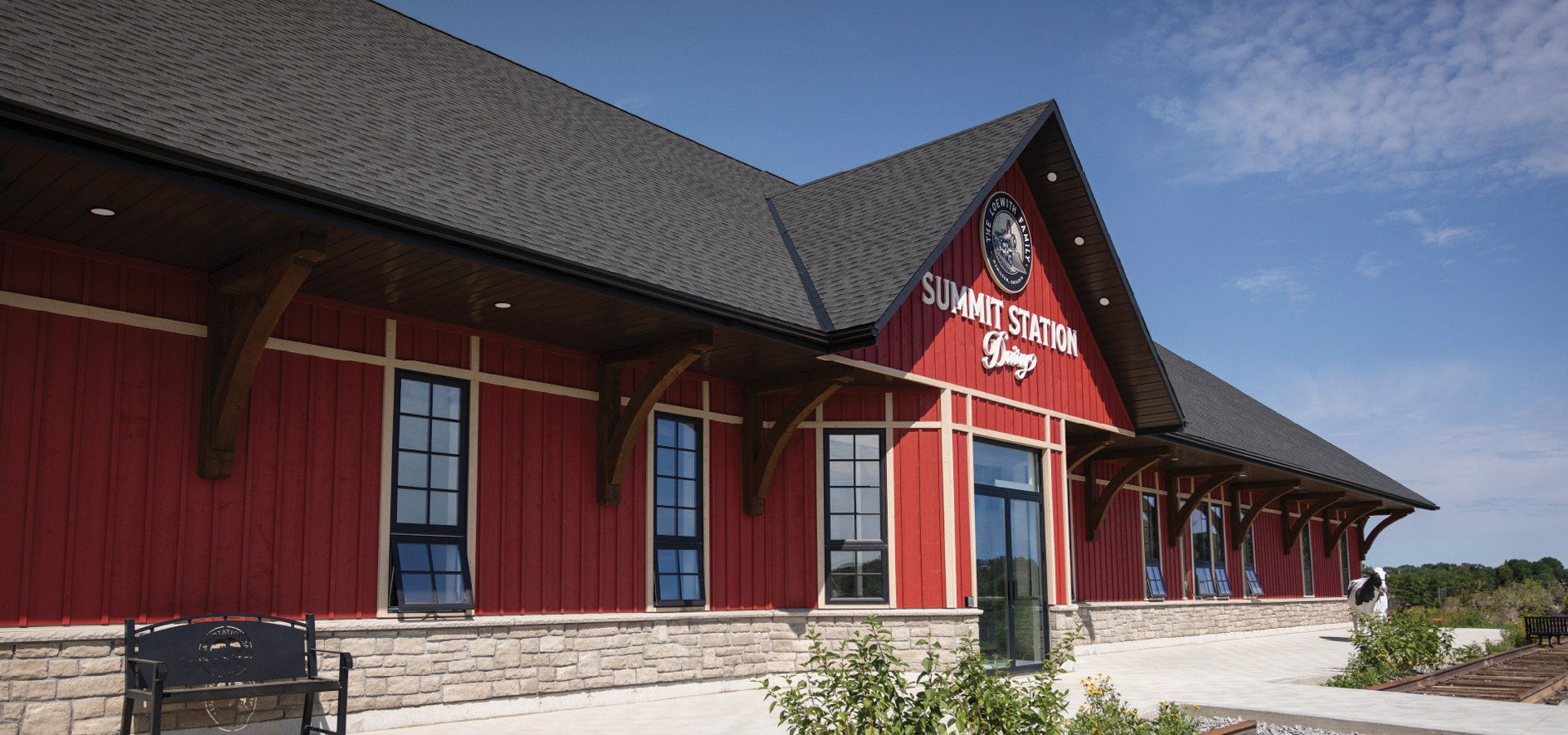 Red board and batten with stone clad exterior photo of the front entrance of Summit Station in Copetown.